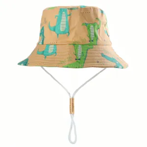 Cute kids cotton bucket hat with cartoon crocodile print and windproof chin strap for outdoor sun.