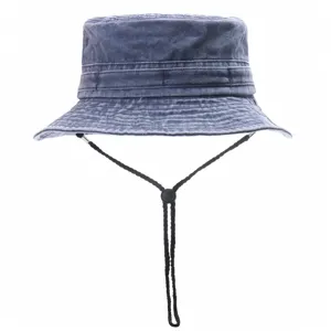 Detailed view of the washed denim bucket hat featuring an adjustable black chin strap.
