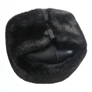 Detailed view of black faux fur winter ushanka hat, warm windproof thick earflap cap.