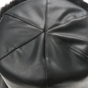 Close-up of black PU leather winter hat top with panel stitching detail for cold weather