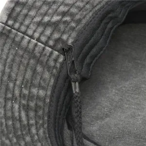 Detailed shot of retro washed cotton bucket hat, featuring adjustable windproof strap.
