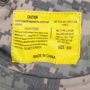 Detailed view of the camouflage sun hat inner care label showing size and material specifications.