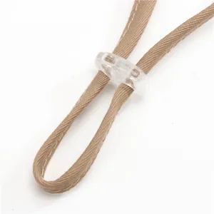 Gros plan sur le cordon de serrage kaki réglable et la boucle en plastique transparent.