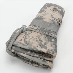 Detailed view of a rolled digital camo bucket hat, showing cotton fabric and drawstring.