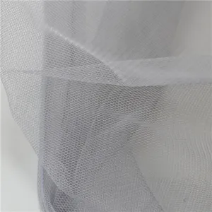 Grey fine mesh fabric detail close-up, showing breathable hexagonal texture and soft material.