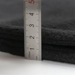 Detailed close-up of thick black fleece fabric highlighting premium thermal insulation quality.