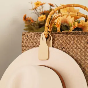 Portable magnetic hat clip for travel, stylish beige rubber holder for outdoor sun hats securely.