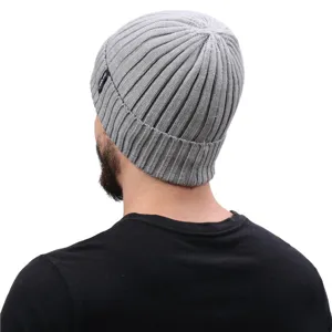 Detail view of the grey ribbed knitted beanie showing the texture and side brand tag.