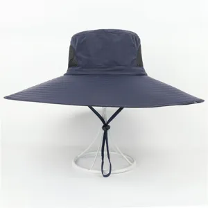 Detailed view of the wide-brim sun hat showing mesh breathability and adjustable chin strap.