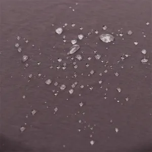 Close-up detail of waterproof fabric texture showing water-repellent performance for summer outdoor hats.