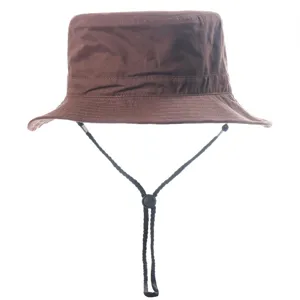 Detail shot of brown bucket hat with adjustable chin strap, outdoor sun protection accessory.