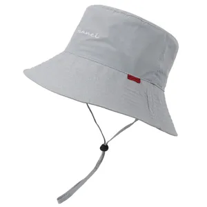 Vue détaillée d'un bob gris avec mentonnière réglable, tissu imperméable et logo brodé.