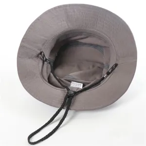 Grey bucket hat detail view, showcasing soft cotton fabric and adjustable chin strap.