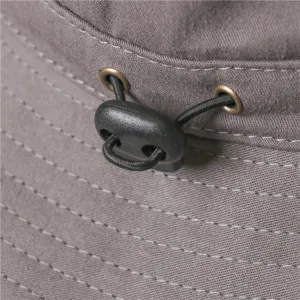 Detail view of the grey bucket hat showcasing adjustable drawcord and metal eyelets.