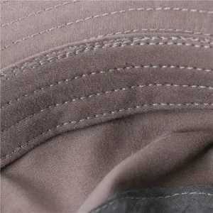 Close-up detail of brown bucket hat showing fine stitching lines and fabric texture.