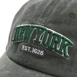 Closeup view of washed cotton baseball hat front embroidery detail in dark gray color