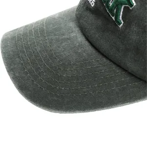 Washed cotton baseball cap detail shot featuring vintage green fabric and durable stitching.