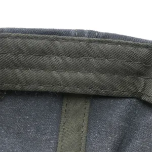 Closeup detail of the inner stitching and washed cotton fabric lining of the baseball cap.