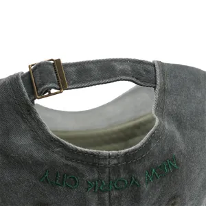 Grey washed cotton baseball cap with adjustable metal buckle and green New York embroidery detail.