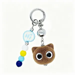 Cute flocked animal charm detail shot, featuring soft brown texture and colorful beads.