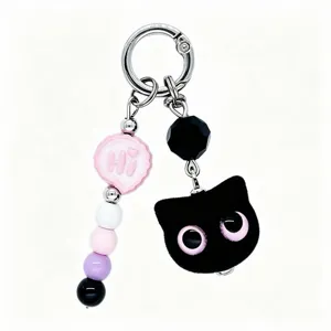 Cute flocked black cat keychain charm with colorful beads and metal clasp detailed view.