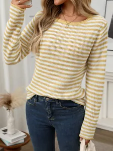 Detailed view of the casual yellow and white striped knit sweater, showcasing cozy texture.