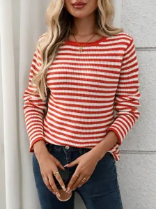 Close-up detail of cozy red and white striped knit sweater with casual crew neck design.
