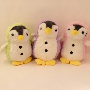 Cute plush penguin toy detail showing soft texture and colorful hoods in green, purple and pink.