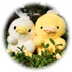 Close-up detail of cute yellow and white plush duck dolls resting among green foliage.