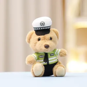 Close-up detail of cute traffic police teddy bear plush pendant showing uniform and hat.