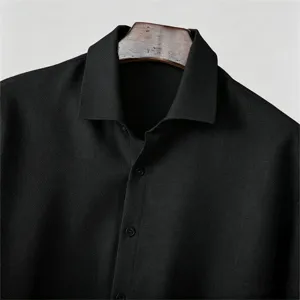 Men's black textured shirt detail, classic lapel collar and comfortable loose fit style.