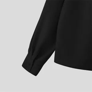 Black textured long sleeve shirt cuff detail, classic casual button-up shirt design.