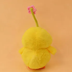 Cute yellow chick plush toy detail shot, featuring a green stem and pink flower, soft and fluffy.