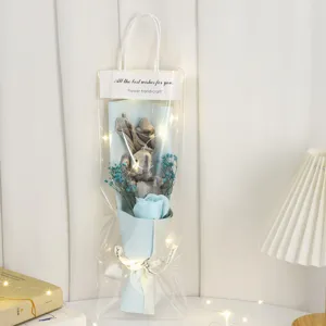 Valentine's Day plush rabbit bouquet with blue soap rose, dried baby's breath and LED lights.