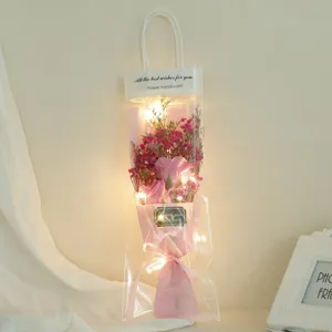 Detailed view of LED string light dried flower bouquet gift bag, warm romantic atmosphere.
