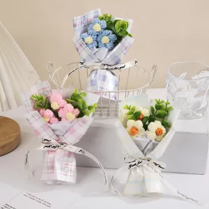 Handmade crochet mini flower bouquet with plaid wrapping paper, perfect gift for Valentine's Day.