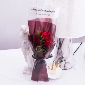 Close-up detail shot of red rose soap flower gift bag with elegant wrapping ribbon.