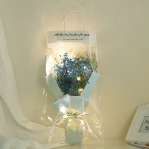 Bagged baby's breath dried flower bouquet with fairy lights in transparent gift bag gift.
