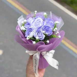 Purple soap rose mini bouquet decorated with white baby's breath, elegant gift wrapping.