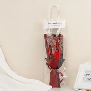 Transparent gift bag with red soap rose and dried baby's breath flowers for romantic occasions.