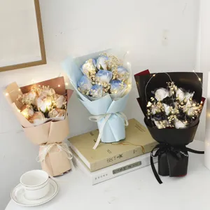 Romantic artificial rose bouquet with fairy lights and gypsophila for special romantic gift.