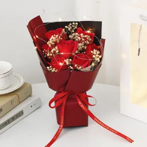 Romantic red rose and baby's breath bouquet with LED string lights and gift bag for romantic gifts.