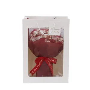 Valentine's Day artificial soap rose bouquet inside a white window gift bag with ribbon tag