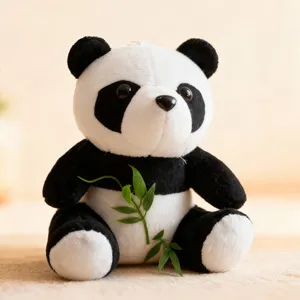 Cute black and white plush panda toy close-up detail, holding small bamboo prop, soft fabric.
