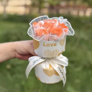 Detail shot of artificial soap rose bouquet in gift wrapping with love text and ribbon.