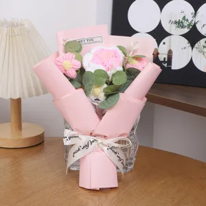 Handcrafted knitted rose flower bouquet in pink wrapper with glass vase for romantic gift.
