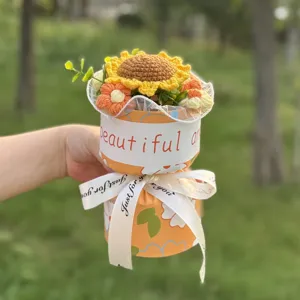Handmade crochet sunflower bouquet gift with beautiful orange wrapping and ribbon.