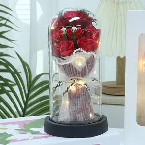 Detailed view of the LED rose soap flower bouquet in a glass dome, romantic gift for lovers.