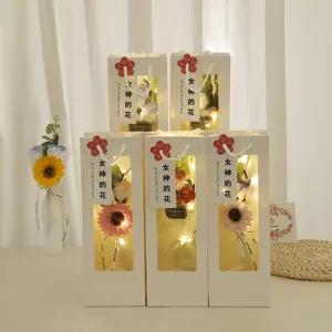 Valentine's day artificial flower gift box with warm string lights for romantic gift.