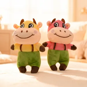 Adorable plush cow stuffed animal toy featuring standing design and green trousers.